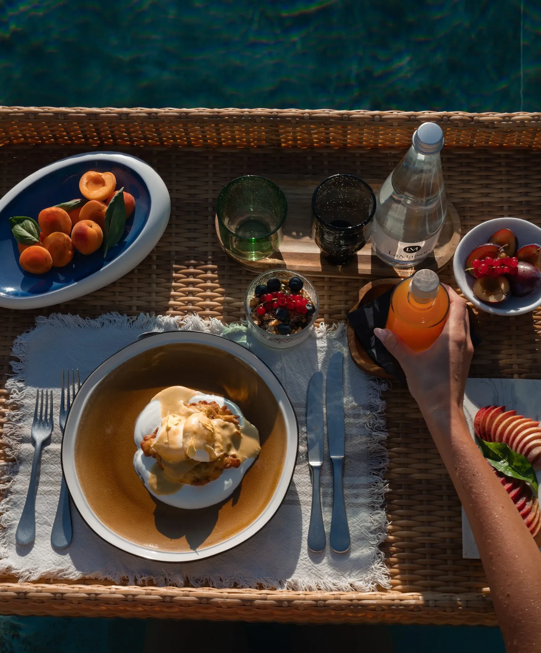 A breakfast tray with eggs, fruit and fresh juice in the morning light at LaMaison