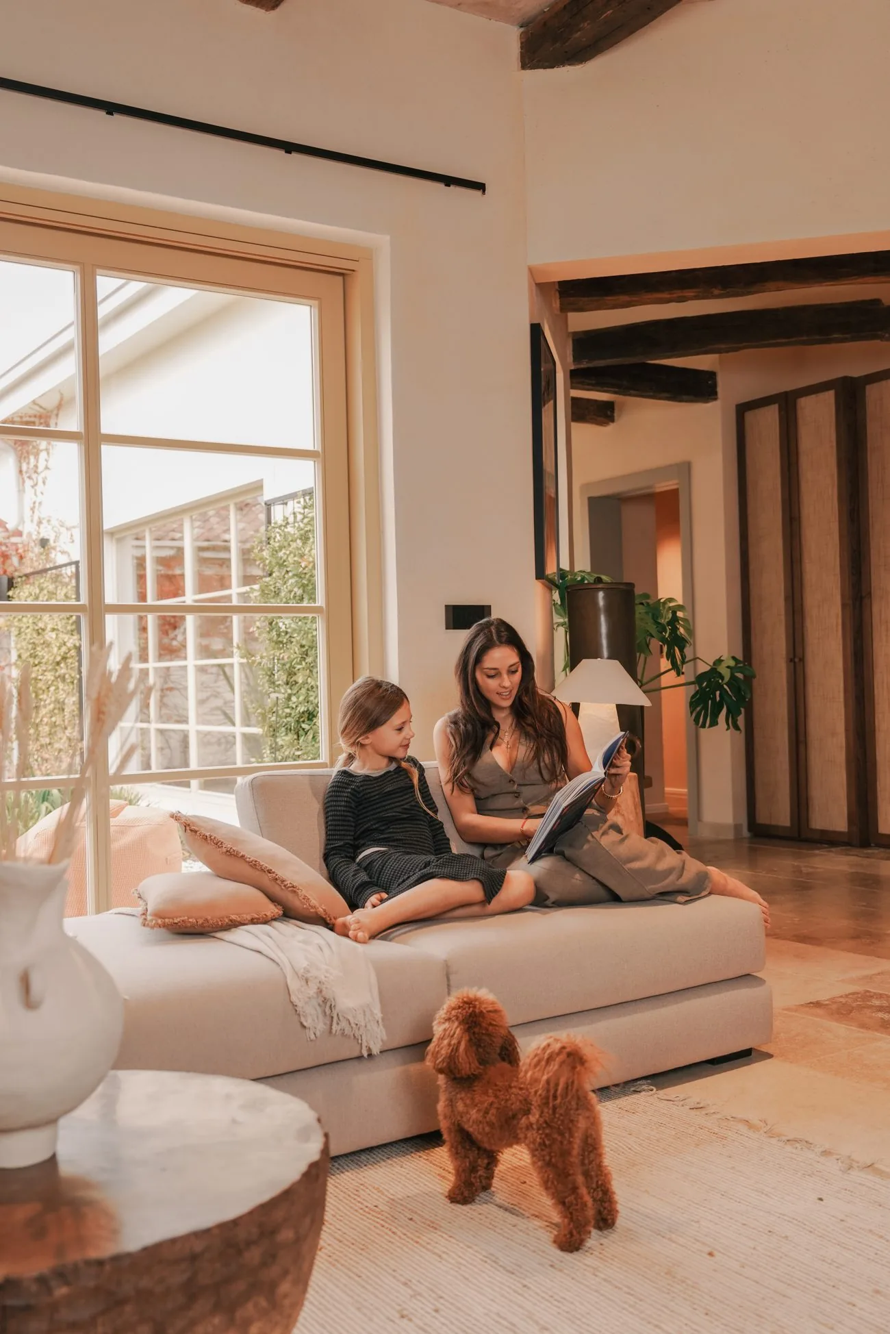 A family reading with the dog in the living room at LaMaison