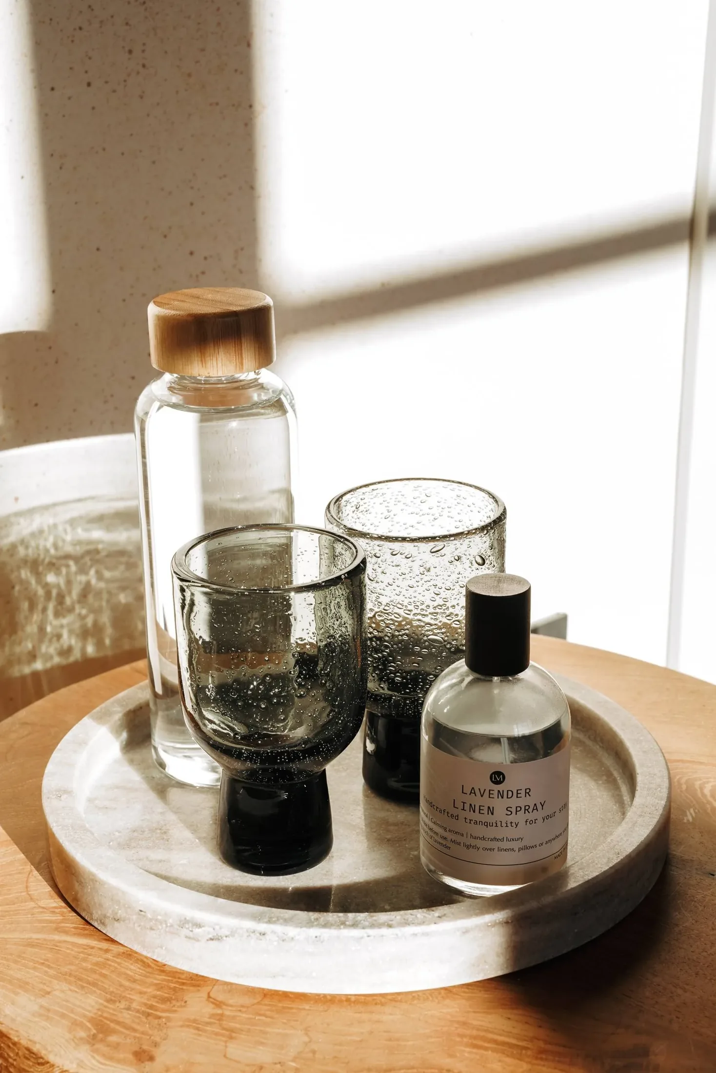 A glass and a LaMaison bottle on the morning tray