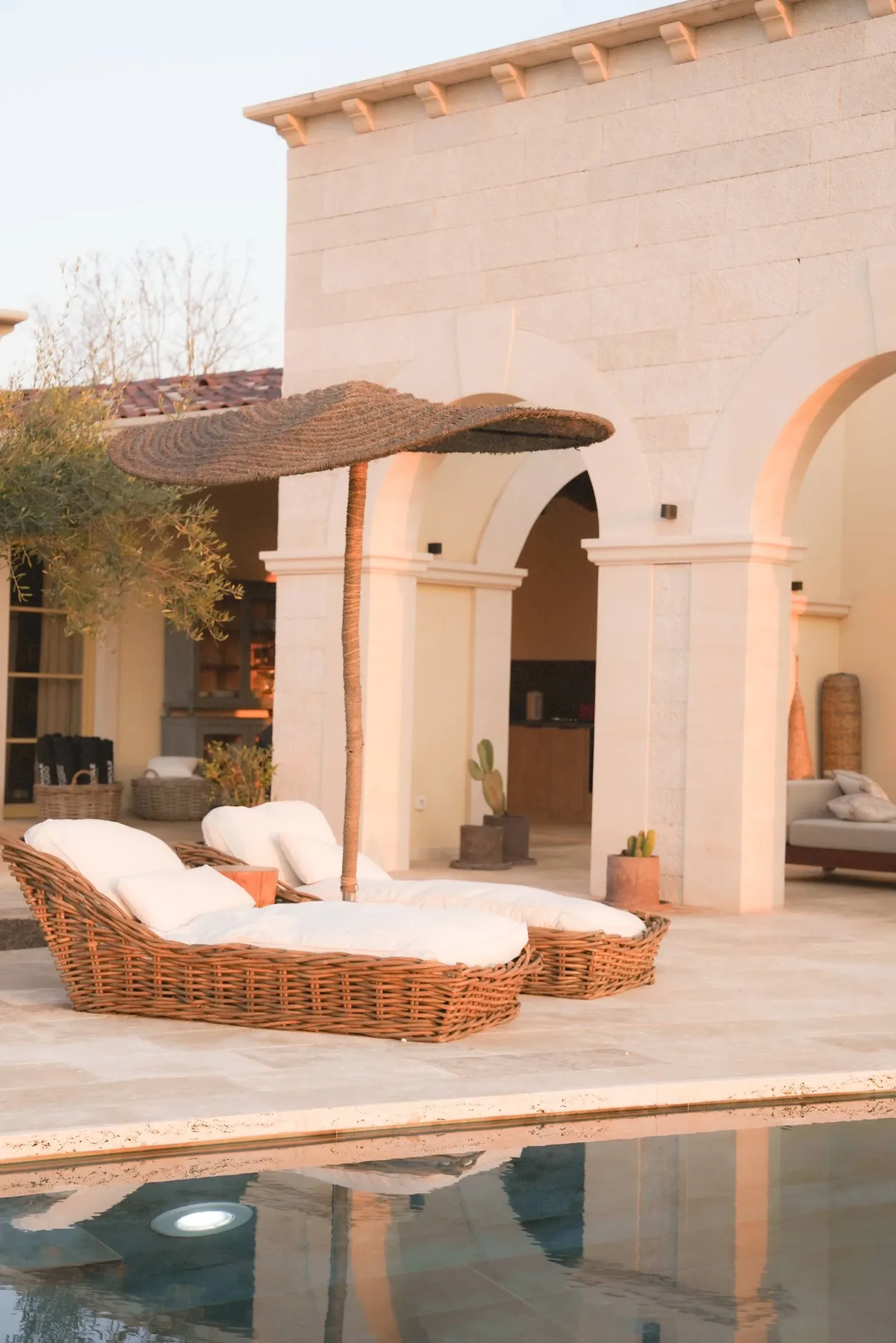 Loungers by the pool in the early light at LaMaison